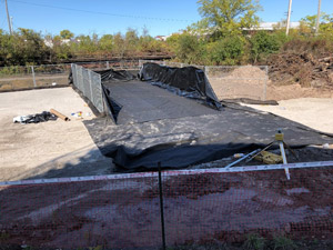 October 2019 - Site 108 - view looking northwest.  Decontamination area set up with nonwoven fabric and liner installed inside temporary construction fence.  